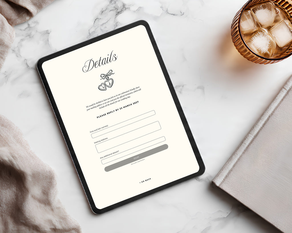 Art deco save the date details page on a tablet beside a marble surface and amber glass, showing the reply-by date and the built-in Canva RSVP form fields.