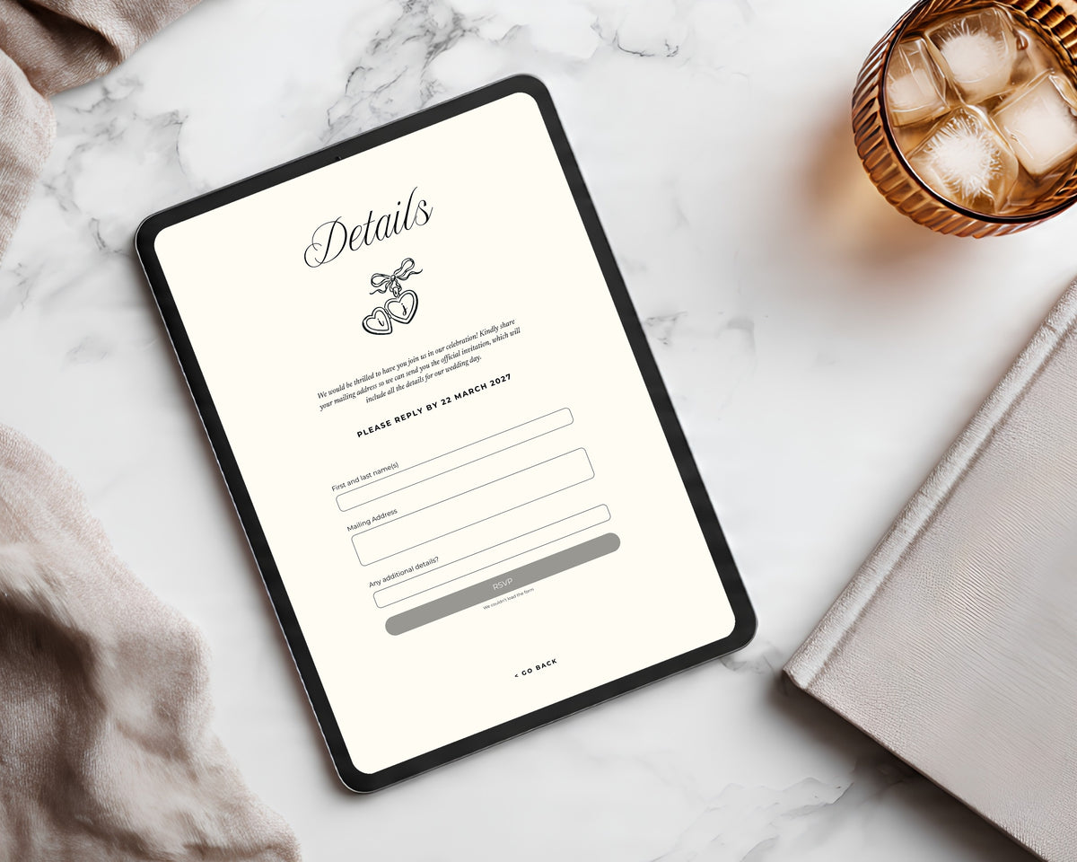 Art deco save the date details page on a tablet beside a marble surface and amber glass, showing the reply-by date and the built-in Canva RSVP form fields.