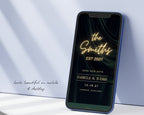 Art deco save the date website on a phone propped against a pale blue wall, showing the neon sign, the couple's names, wedding date and city.