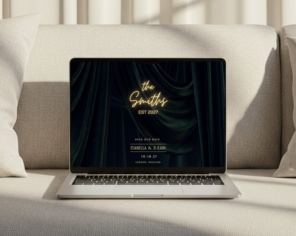 Art deco save the date wedding website open on a laptop on a sofa, showing the neon marquee with the couple's names and wedding date.