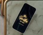 Art deco save the date neon entrance page on a phone resting on a green marble side table.