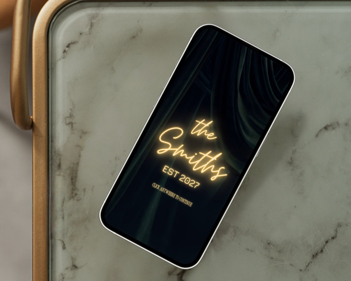Art deco save the date neon entrance page on a phone resting on a green marble side table.