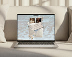 Save the date website template shown on a laptop, with the coastal envelope invitation on screen.