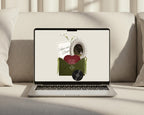 Olive green save the date website shown on a laptop, with the opened envelope invitation on screen.