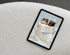 Coastal save the date website template on a tablet, showing the opened envelope invitation with couple photos and a save-the-date ticket.
