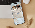 Digital save the date website on a phone, styled on a wooden desk beside a keyboard.