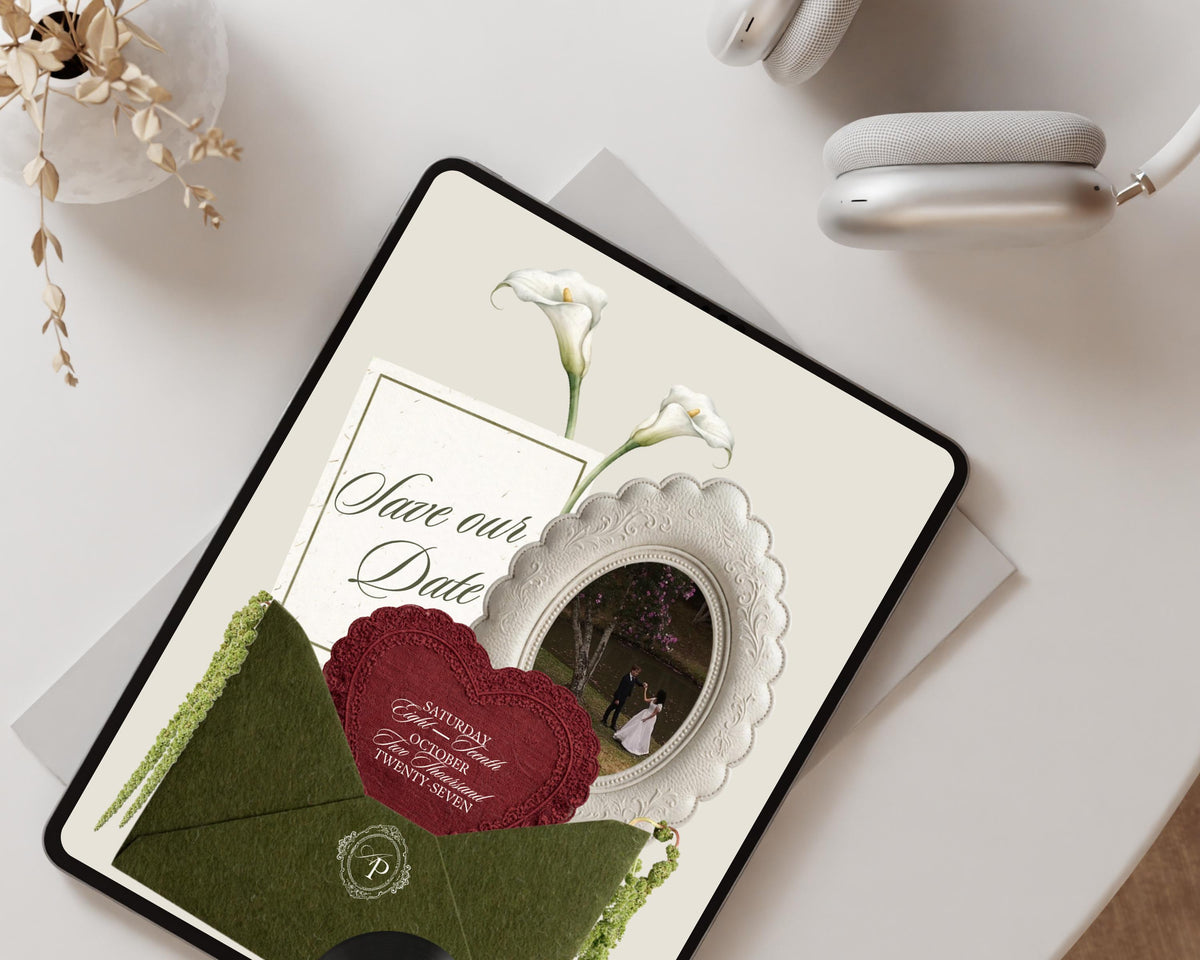Olive green classical save the date website on a tablet in a flat-lay styled with dried florals.