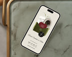 Olive green save the date website displayed on a phone, styled on a marble tray.
